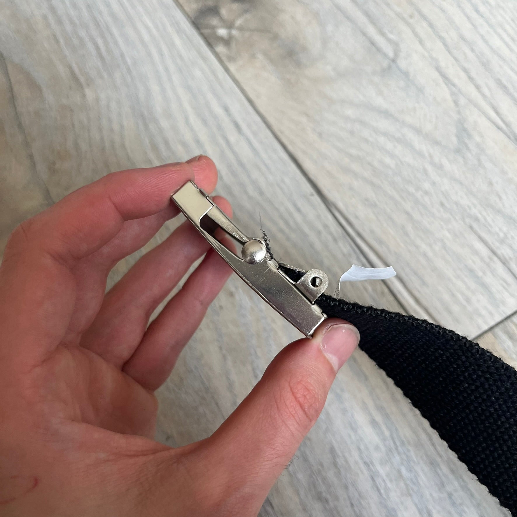 Gamerswear Counter-Strike 2016 Black Belt is a black cotton belt with an adjustable fit and a metal tip featuring a cutout Gamerswear logo. The buckle showcases an armed character in a silver finish, framed by blue enamel on the left side and red enamel on the right. The central figure is highlighted with a raised silver design and matching silver border detailing.