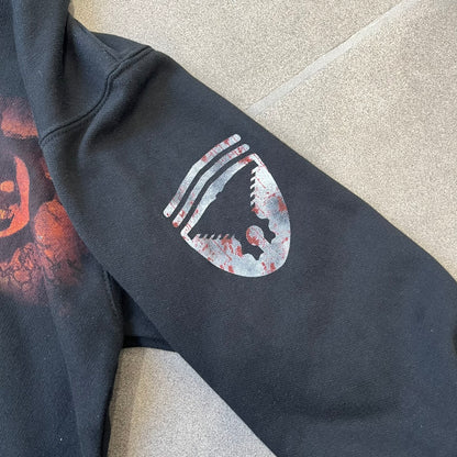 Gears of War 3 Marcus Fenix 2010 Promo Hoodie is a black zip-up hoodie with a dark Crimson Omen logo in orange tones on the left upper chest and a bloody Delta-One logo on one sleeve. The back features a large Marcus Fenix graphic with “Gears of War 3” text below it and a small 2010 Epic Games licensing mark.