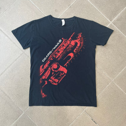 Gears of War 2 2008 Red Lancer Tee is a black, 100% cotton T-shirt featuring a large red Lancer graphic on the front alongside small white "Gears of War 2" text. The upper back displays the GOW2 skull logo with 2008 licensing below.