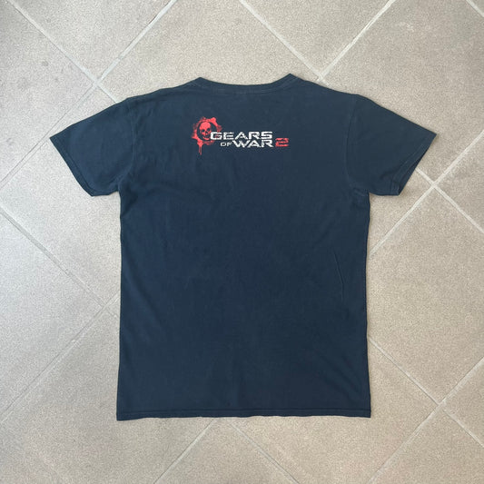 Gears of War 2 2008 Red Lancer Tee is a black, 100% cotton T-shirt featuring a large red Lancer graphic on the front alongside small white "Gears of War 2" text. The upper back displays the GOW2 skull logo with 2008 licensing below.