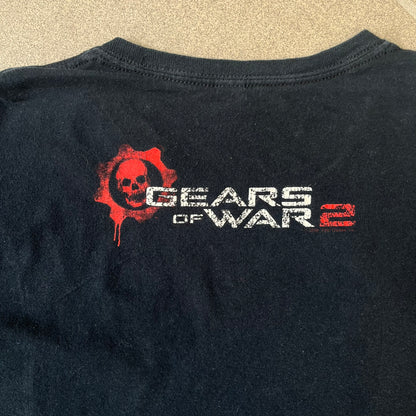 Gears of War 2 2008 Red Lancer Tee is a black, 100% cotton T-shirt featuring a large red Lancer graphic on the front alongside small white "Gears of War 2" text. The upper back displays the GOW2 skull logo with 2008 licensing below.