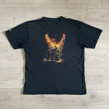 Black Gears of War Tee for Xbox 360 with a small red skull front logo on the chest and white Xbox 360 logo on the sleeve. The back features a full-color cover graphic with Marcus Fenix and branding of the game and Epic Games. Xbox tagged on the side, wash tag is faded.