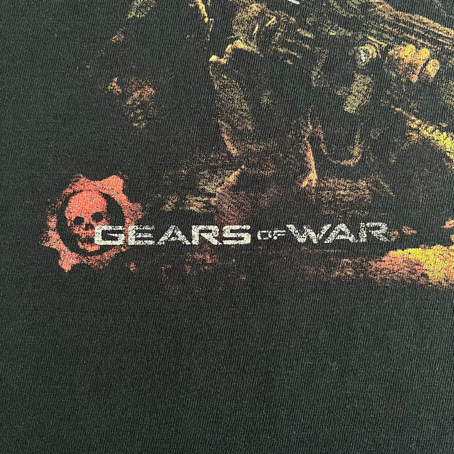 Black Gears of War Tee for Xbox 360 with a small red skull front logo on the chest and white Xbox 360 logo on the sleeve. The back features a full-color cover graphic with Marcus Fenix and branding of the game and Epic Games. Xbox tagged on the side, wash tag is faded.