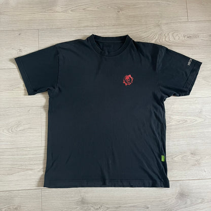 Black Gears of War Tee for Xbox 360 with a small red skull front logo on the chest and white Xbox 360 logo on the sleeve. The back features a full-color cover graphic with Marcus Fenix and branding of the game and Epic Games. Xbox tagged on the side, wash tag is faded.