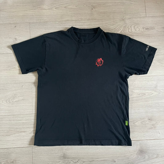 Black Gears of War Tee for Xbox 360 with a small red skull front logo on the chest and white Xbox 360 logo on the sleeve. The back features a full-color cover graphic with Marcus Fenix and branding of the game and Epic Games. Xbox tagged on the side, wash tag is faded.