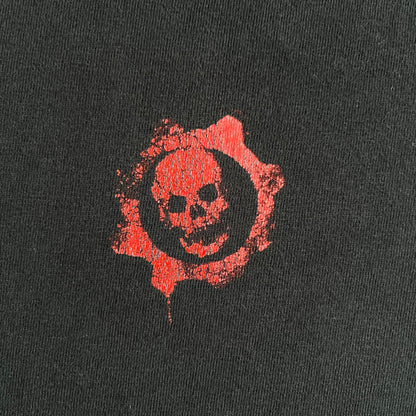 Black Gears of War Tee for Xbox 360 with a small red skull front logo on the chest and white Xbox 360 logo on the sleeve. The back features a full-color cover graphic with Marcus Fenix and branding of the game and Epic Games. Xbox tagged on the side, wash tag is faded.
