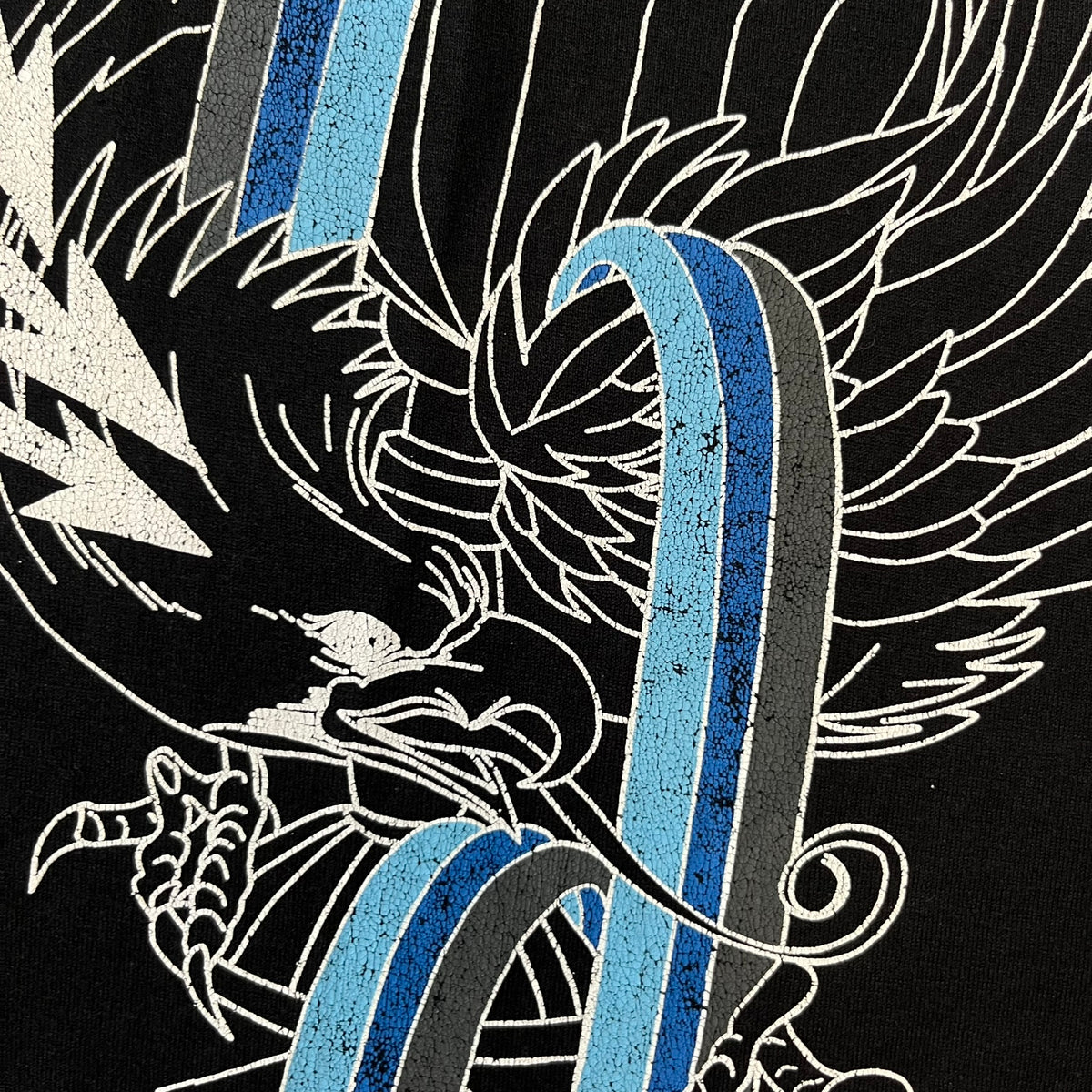 Givenchy AW18 Aquarius Black Tee is a black, slim-fit T-shirt made from 100% cotton, featuring white "GIVENCHY" text on the front alongside a blue half-moon-shaped graphics. The back displays an Aquarius-inspired design in white, gray, and blue, depicting a fountain with a large bird, a cube built from repeated Givenchy logos, and a Givenchy signature.