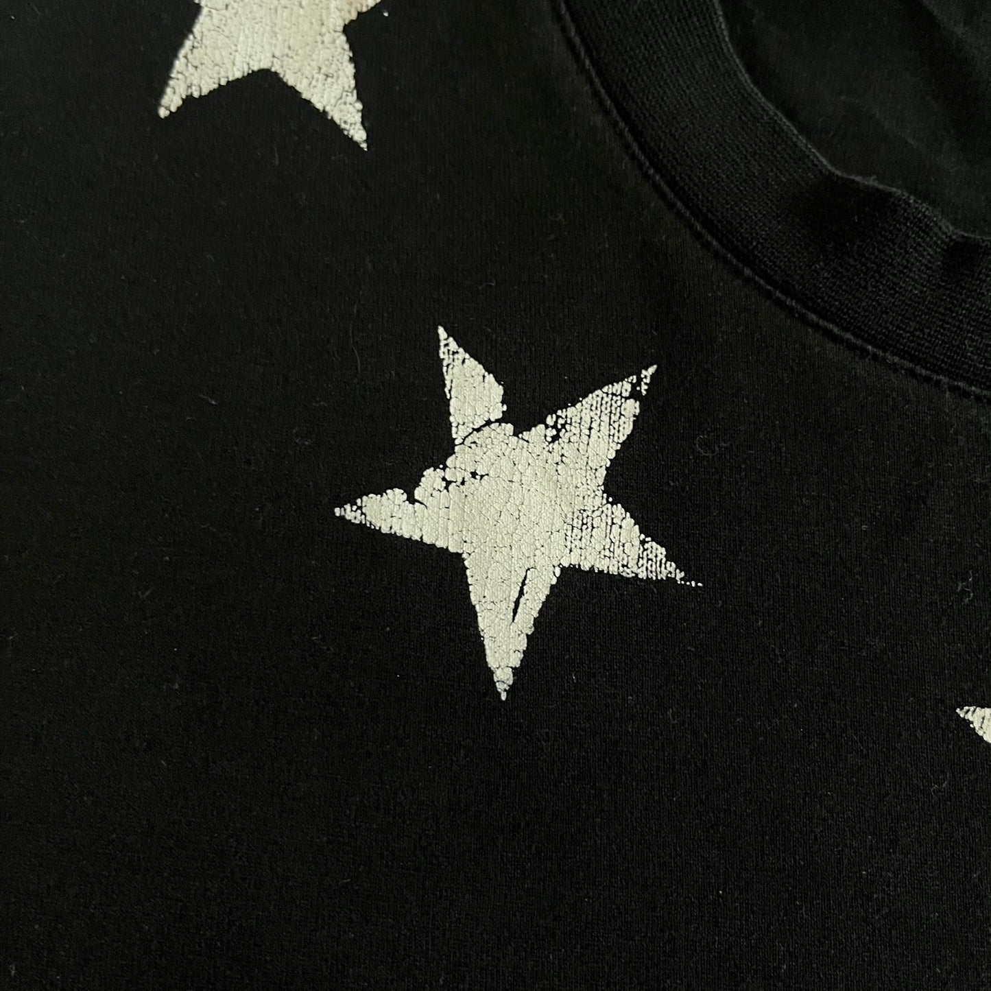 This Givenchy Distressed Black Stars Tee features the label’s iconic star motif from the FW18 season, with five stars across the front collar and four at the back. Crafted in Portugal from 100% cotton, it offers a slim fit and a soft, ribbed crewneck finish. A sought-after Givenchy stars shirt, and yes the distressed stars are intentional, not due to wear.