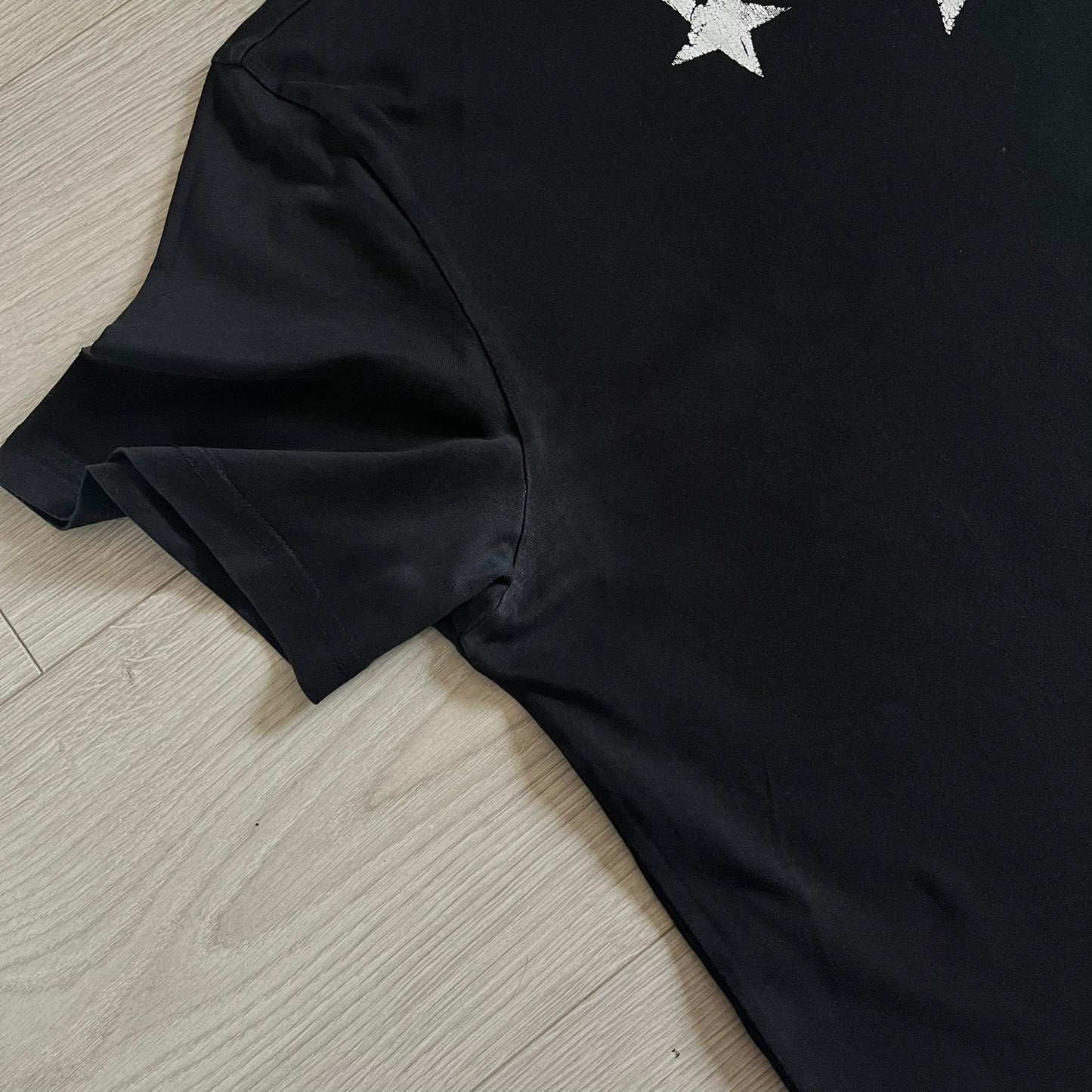 This Givenchy Distressed Black Stars Tee features the label’s iconic star motif from the FW18 season, with five stars across the front collar and four at the back. Crafted in Portugal from 100% cotton, it offers a slim fit and a soft, ribbed crewneck finish. A sought-after Givenchy stars shirt, and yes the distressed stars are intentional, not due to wear.