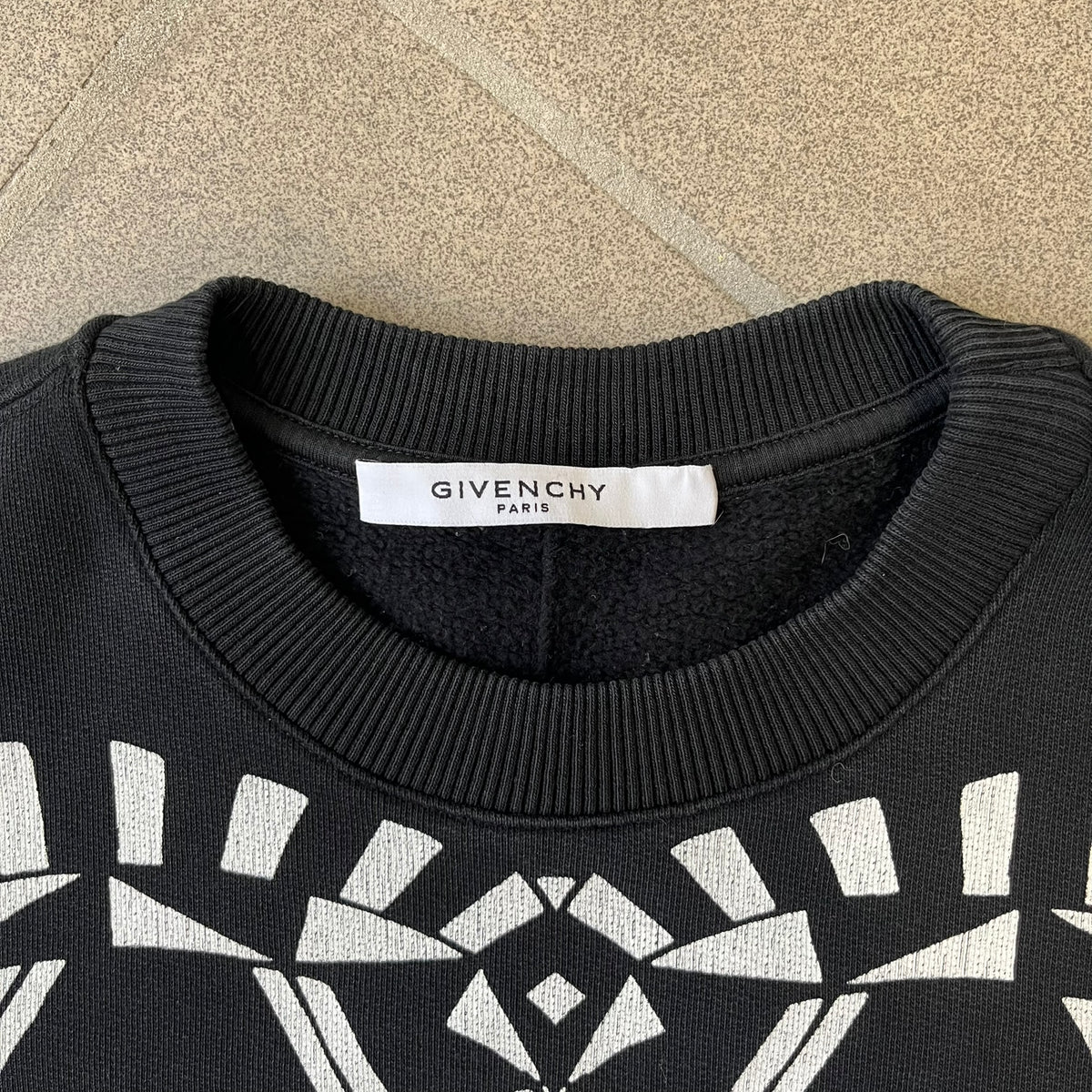 Givenchy FW16 "I Believe in the Power of Love" Crewneck is a black crewneck made from 100% cotton, featuring a white graphic heart built from varying patterns that grow from small to large, with "I Believe in the Power of Love" text placed at its center.&nbsp;