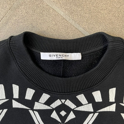 Givenchy FW16 "I Believe in the Power of Love" Crewneck is a black crewneck made from 100% cotton, featuring a white graphic heart built from varying patterns that grow from small to large, with "I Believe in the Power of Love" text placed at its center.&nbsp;