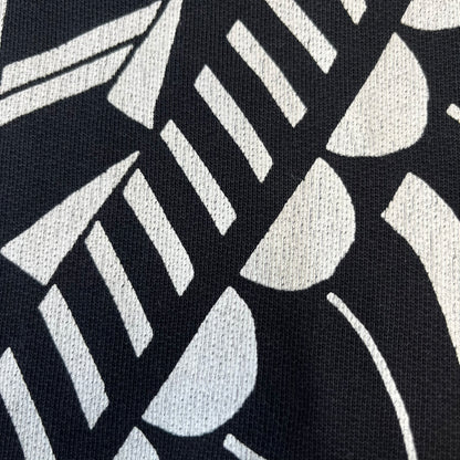 Givenchy FW16 "I Believe in the Power of Love" Crewneck is a black crewneck made from 100% cotton, featuring a white graphic heart built from varying patterns that grow from small to large, with "I Believe in the Power of Love" text placed at its center.&nbsp;