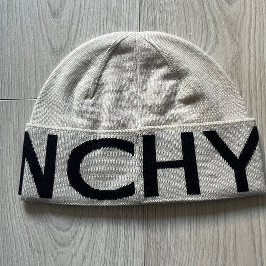 Beige Givenchy Jacquard beanie made from 100% wool and crafted in Italy. Features the black contrasting logo around the rolled brim, splitting “GIVE” and “NCHY” across the hem.&nbsp;Premium construction with a soft, comfortable fit.