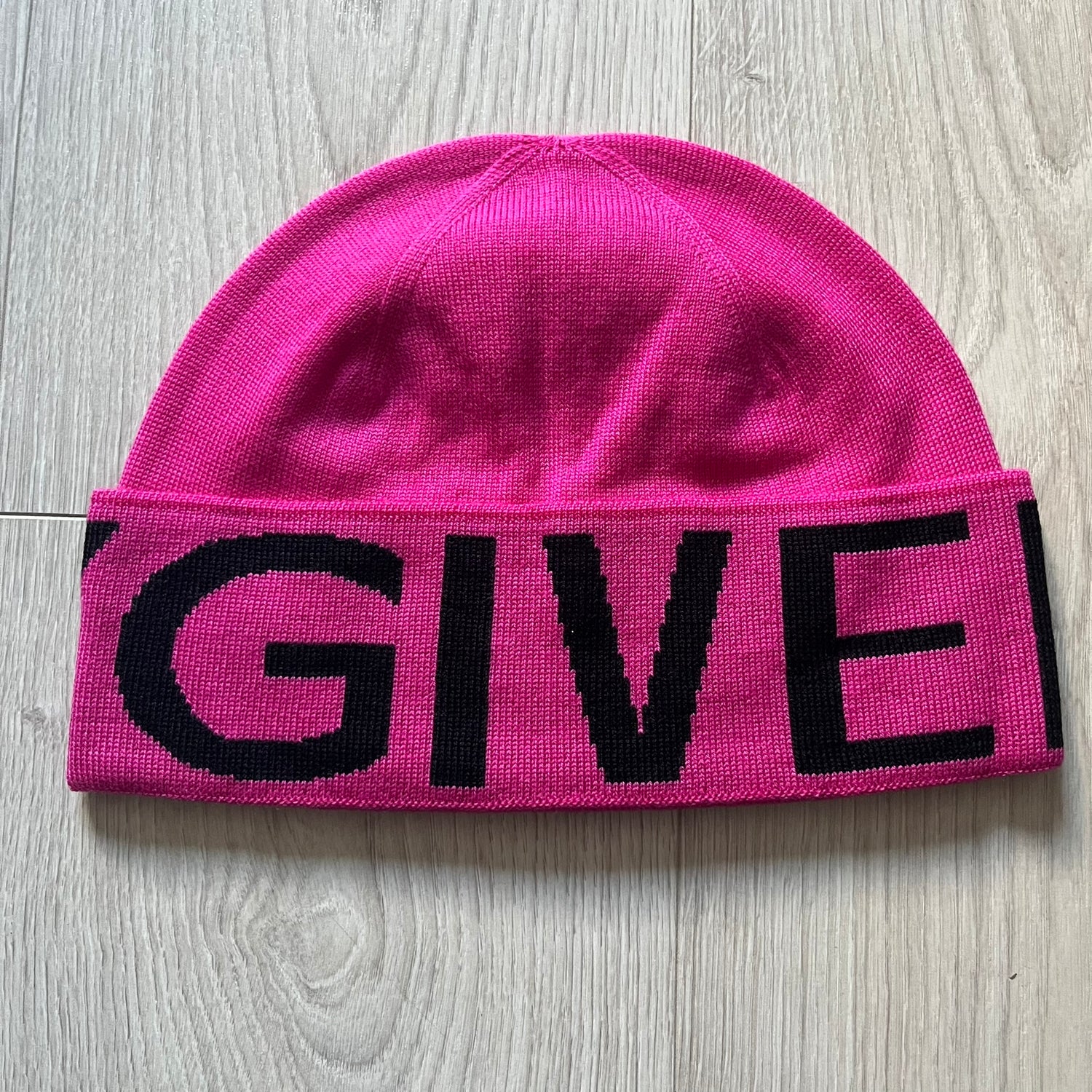 Pink Givenchy Jacquard beanie made from 100% wool and crafted in Italy. Features the black contrasting logo around the rolled brim, splitting “GIVE” and “NCHY” across the hem. Premium construction with a soft, comfortable fit.