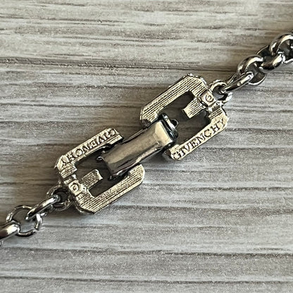 Givenchy Silver Enameled “G” Necklace from the late 1970s to early 1980s, crafted in silver with ten interlinked G-shaped triangular segments filled with black enamel. Signed Givenchy on the clasp. A rare collector’s jewelry item from Givenchy’s early archives.