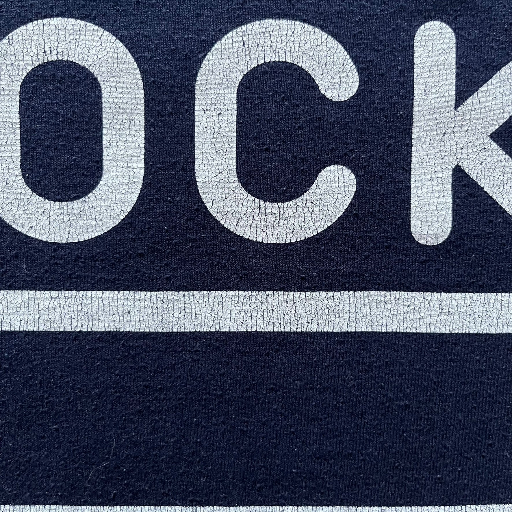 Navy Glock Perfection Tee from the 2000s, made on a Hanes Heavyweight 50/50 cotton-poly blend. Features a large white Glock Perfection logo on the back and a smaller matching logo on the left chest. Thick, high-quality construction.