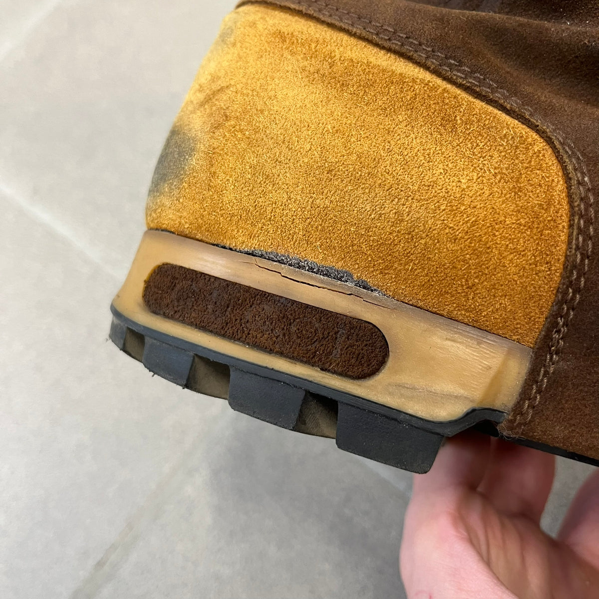 Gucci 2000’s Beige & Brown Shearling Lined Boots are made in Italy from beige and brown suede with a shearling-lined interior. A velcro strap with a Gucci logo closes the top, and the tongue has a leather tab with the Gucci logo. A green and red stripe runs around the top, a GG logo is on the side, and another GG logo appears on the sole along with a small one at the toe tip and a brown leather Gucci logo section on the sole. Due to age, the sole is falling apart and needs either gluing or a sole replacemen