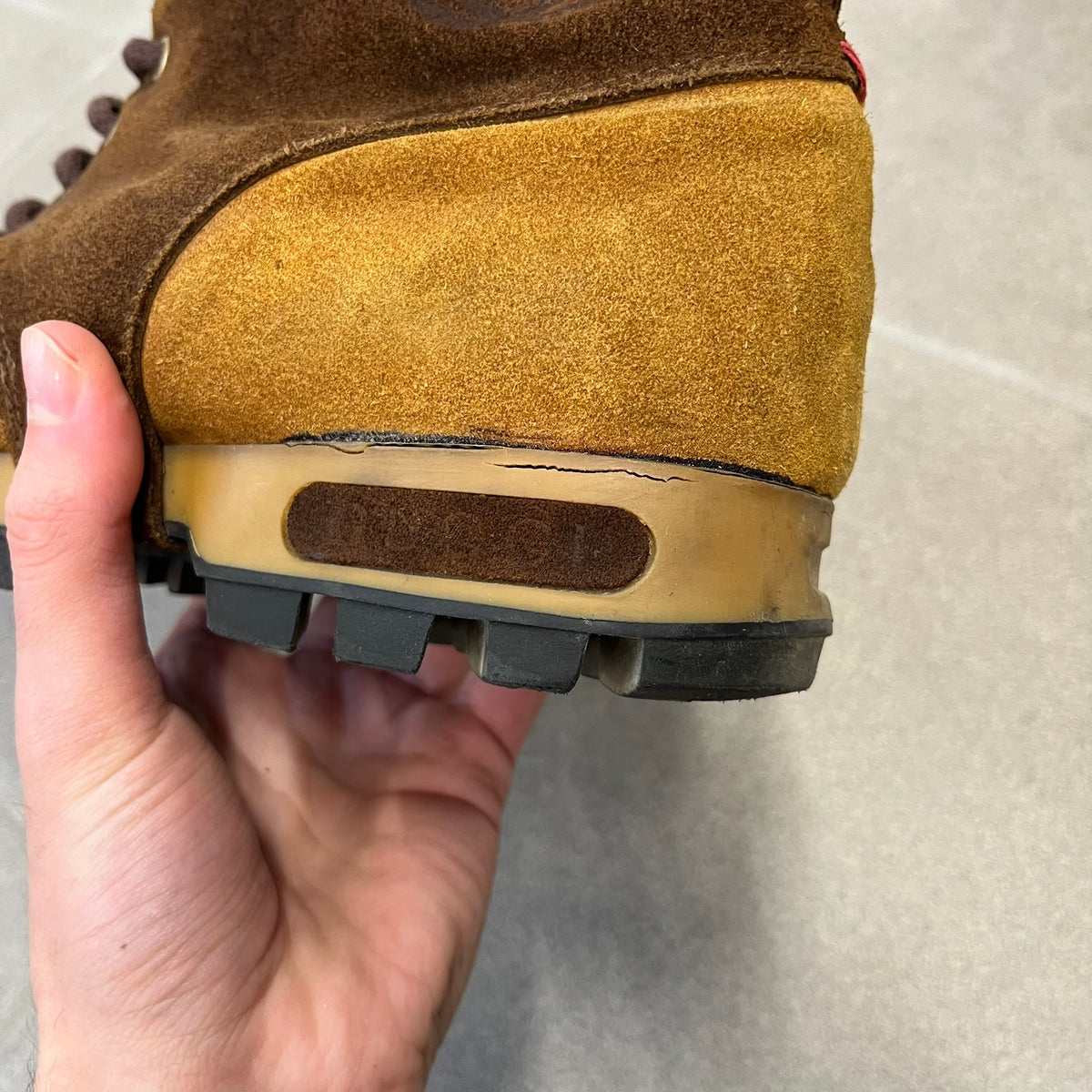 Gucci 2000’s Beige & Brown Shearling Lined Boots are made in Italy from beige and brown suede with a shearling-lined interior. A velcro strap with a Gucci logo closes the top, and the tongue has a leather tab with the Gucci logo. A green and red stripe runs around the top, a GG logo is on the side, and another GG logo appears on the sole along with a small one at the toe tip and a brown leather Gucci logo section on the sole. Due to age, the sole is falling apart and needs either gluing or a sole replacemen