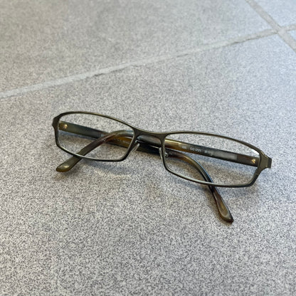 Gucci GG 1721 3U0 Brown Eyeglasses are a Made in Italy optical frame featuring a square full-rim design with a brown Havana-style colorway. The frames combine metal and plastic construction with a subtle Gucci logo detail on the front. Designed as a unisex model, they include prescription lenses and offer 100% UVA protection. Comes with an original black Gucci case.
