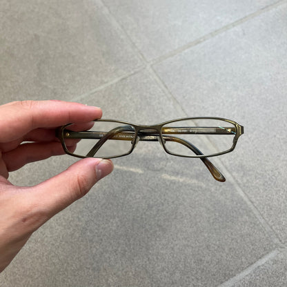 Gucci GG 1721 3U0 Brown Eyeglasses are a Made in Italy optical frame featuring a square full-rim design with a brown Havana-style colorway. The frames combine metal and plastic construction with a subtle Gucci logo detail on the front. Designed as a unisex model, they include prescription lenses and offer 100% UVA protection. Comes with an original black Gucci case.
