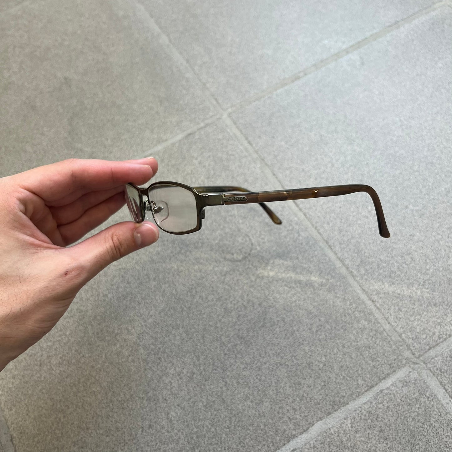 Gucci GG 1721 3U0 Brown Eyeglasses are a Made in Italy optical frame featuring a square full-rim design with a brown Havana-style colorway. The frames combine metal and plastic construction with a subtle Gucci logo detail on the front. Designed as a unisex model, they include prescription lenses and offer 100% UVA protection. Comes with an original black Gucci case.

