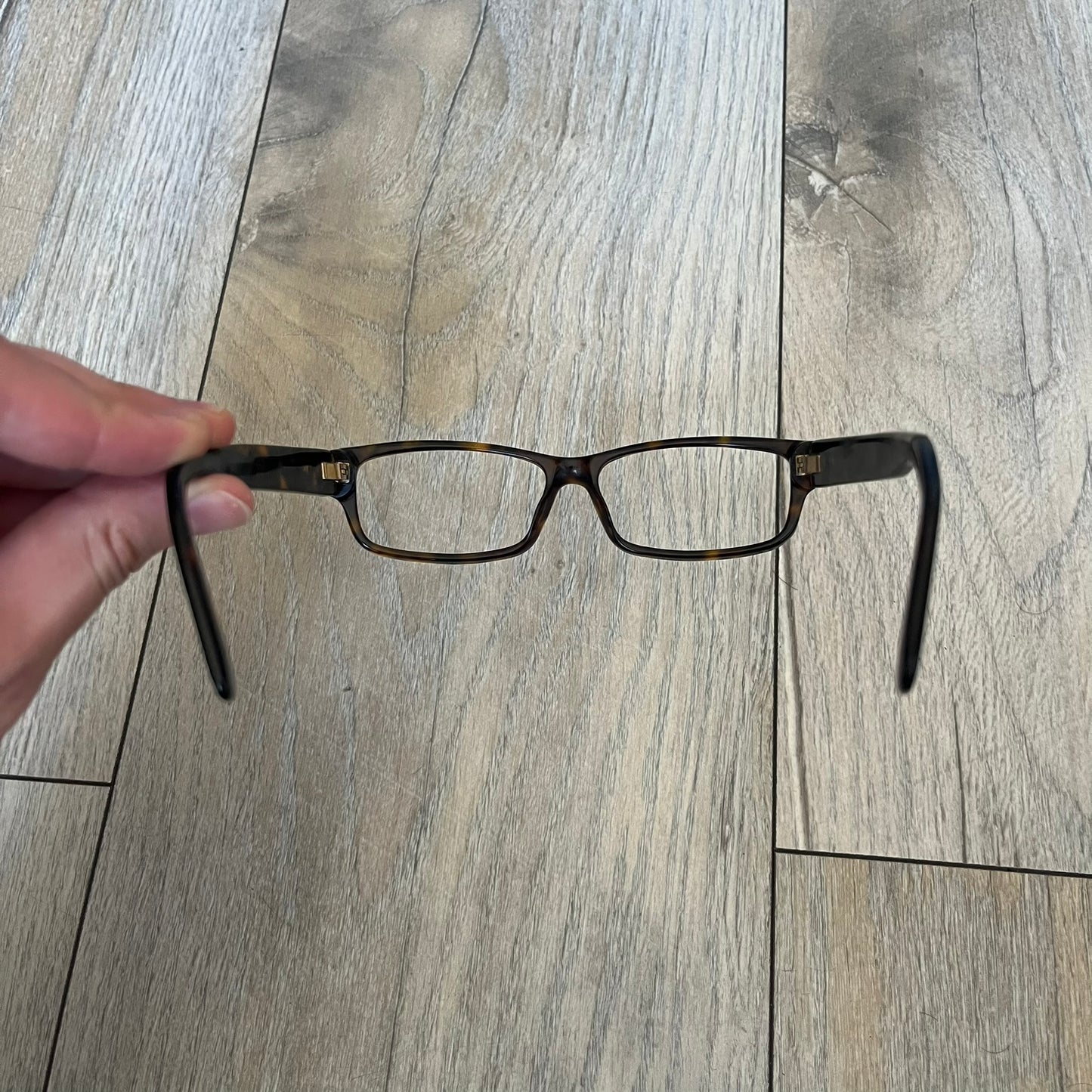 Gucci GG 3080 086 Glasses Frames are eyeglass frames made in Italy, featuring a brown and orange-toned acetate construction. The temples are detailed with silver GG monogram pattern accents and Gucci’s signature red and green web stripe near the front of the arms. The frames come with a matching monogram Gucci case.