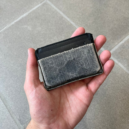Gucci GG Supreme Kingsnake Card Holder features black and grey GG Supreme canvas with a red and black Kingsnake graphic and black leather trim. It has two card slots on the front, two on the back, and one central slot at the top.
