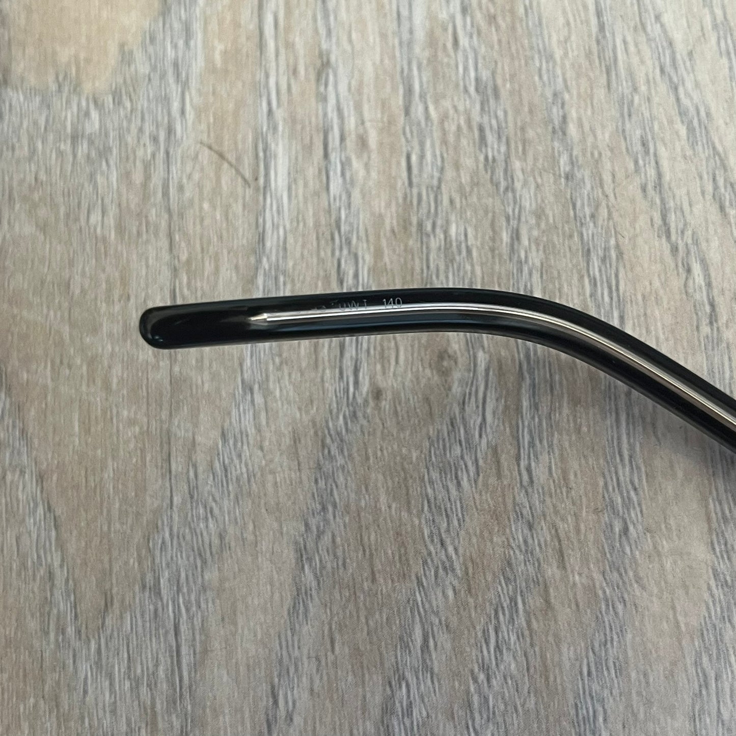 Gucci Gray-Blue Glasses Frames feature a translucent gray and dark blue acetate construction with a clear finish. Small silver GG logos are positioned on the front sides of the frames near the hinges. The frames are sold without lenses and come with a Gucci monogram case and a brown cleaning cloth.