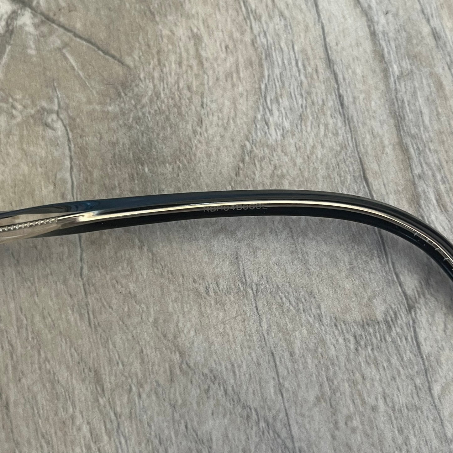 Gucci Gray-Blue Glasses Frames feature a translucent gray and dark blue acetate construction with a clear finish. Small silver GG logos are positioned on the front sides of the frames near the hinges. The frames are sold without lenses and come with a Gucci monogram case and a brown cleaning cloth.