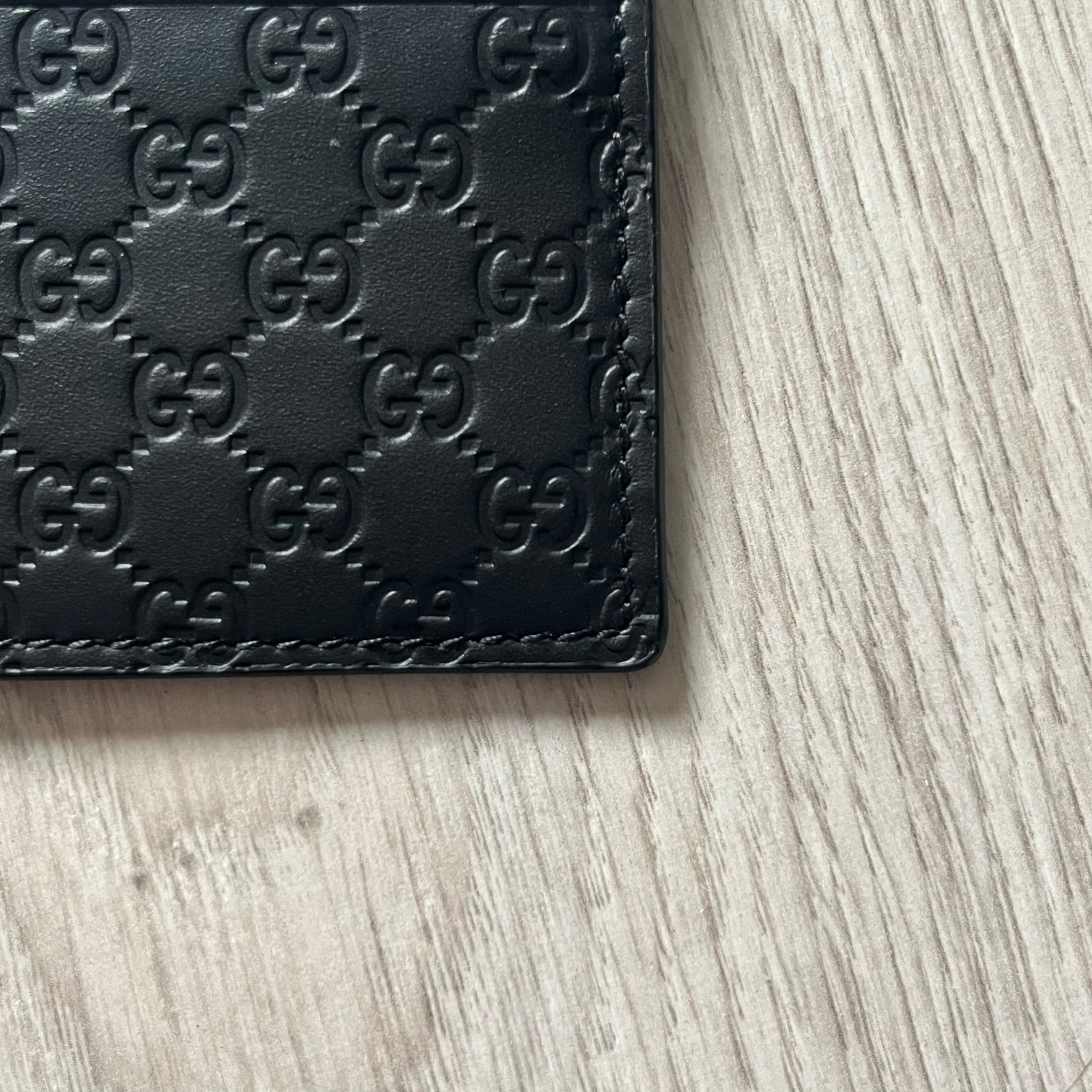 Gucci Microguccissima Black Cardholder crafted in Italy from premium black calf leather with the iconic Microguccissima pattern. Features five card slots, including a central compartment for bills or additional cards. Compact and refined, this Gucci leather card case combines durability with timeless design.