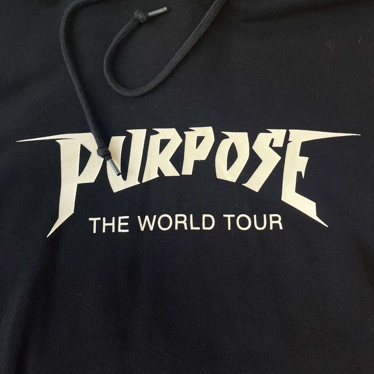 H&amp;M 2016 Justin Bieber Purpose World Tour Black Hoodie is from the 2016 H&amp;M Divided collaboration collection, featuring a white "Purpose" logo with "World Tour" text below it on the front. Both sleeves display big red "WORLD TOUR" text.