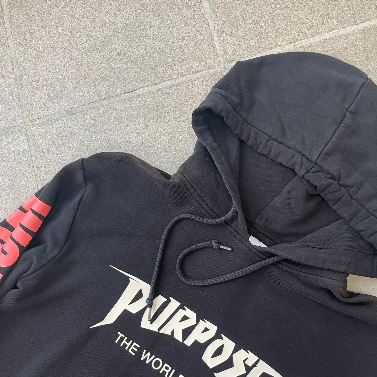 H&amp;M 2016 Justin Bieber Purpose World Tour Black Hoodie is from the 2016 H&amp;M Divided collaboration collection, featuring a white "Purpose" logo with "World Tour" text below it on the front. Both sleeves display big red "WORLD TOUR" text.