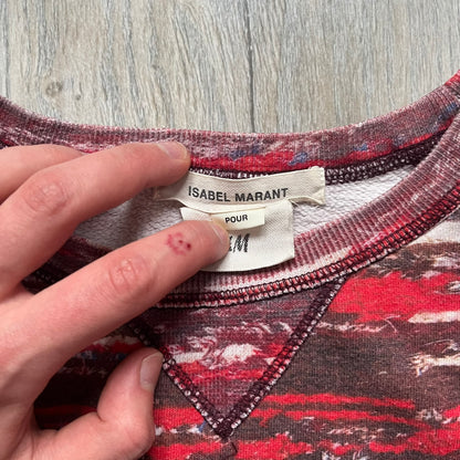 H&M x Isabel Marant 2013 Red Disorder Sweater is a women’s knit sweater in red, made from a soft fabric blend. The sweater features a deliberately distressed knit throughout, with ribbed cuffs and hem for structure. It was released as part of the H&M x Isabel Marant 2013 collaboration.