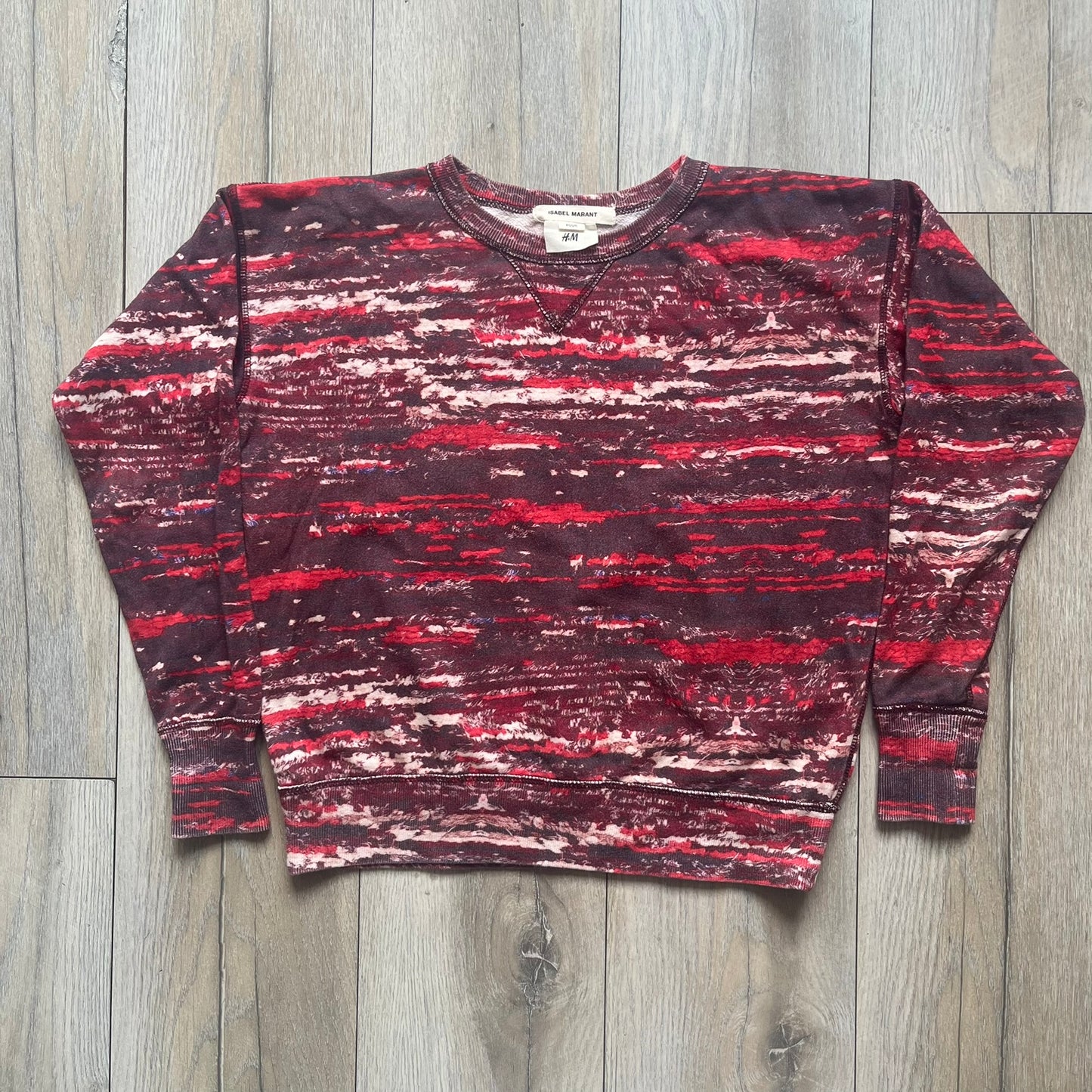 H&amp;M x Isabel Marant 2013 Red Disorder Sweater is a women’s knit sweater in red, made from a soft fabric blend. The sweater features a deliberately distressed knit throughout, with ribbed cuffs and hem for structure. It was released as part of the H&amp;M x Isabel Marant 2013 collaboration