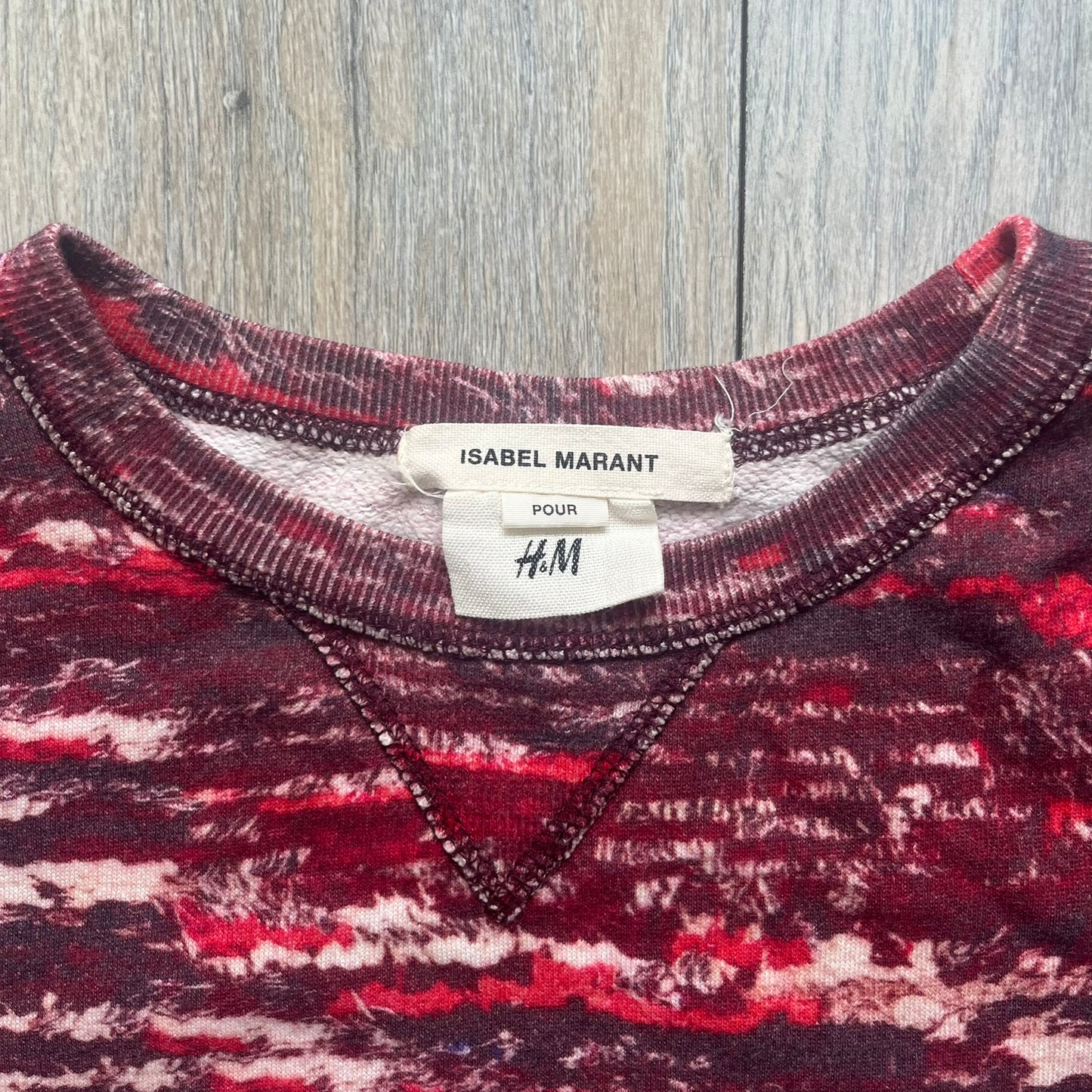 H&amp;M x Isabel Marant 2013 Red Disorder Sweater is a women’s knit sweater in red, made from a soft fabric blend. The sweater features a deliberately distressed knit throughout, with ribbed cuffs and hem for structure. It was released as part of the H&amp;M x Isabel Marant 2013 collaboration