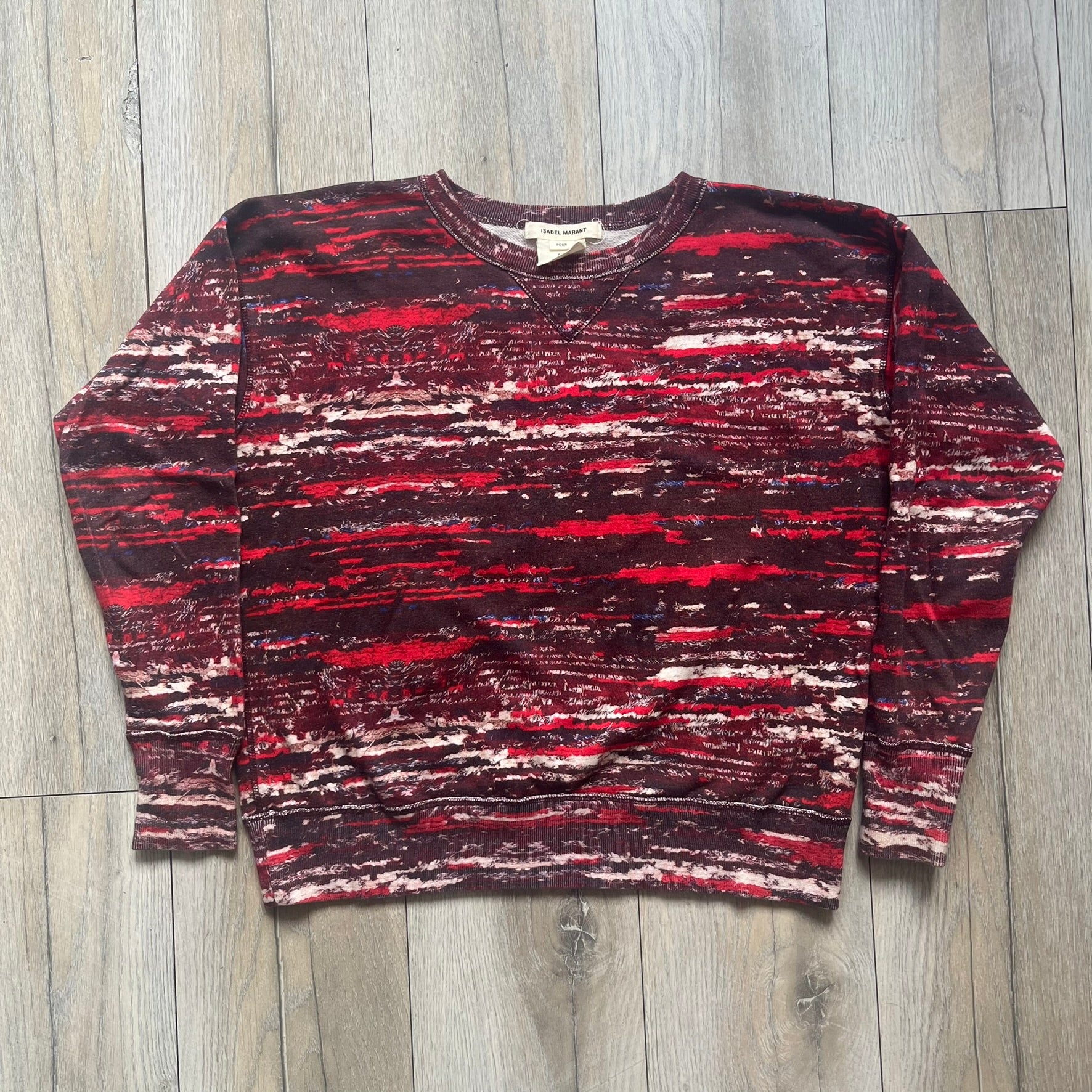 H&amp;M x Isabel Marant 2013 Red Disorder Sweater is a women’s knit sweater in red, made from a soft fabric blend. The sweater features a deliberately distressed knit throughout, with ribbed cuffs and hem for structure. It was released as part of the H&amp;M x Isabel Marant 2013 collaboration.&nbsp;