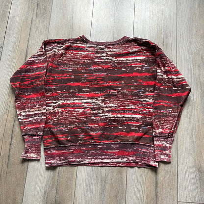 H&M x Isabel Marant 2013 Red Disorder Sweater is a women’s knit sweater in red, made from a soft fabric blend. The sweater features a deliberately distressed knit throughout, with ribbed cuffs and hem for structure. It was released as part of the H&M x Isabel Marant 2013 collaboration.