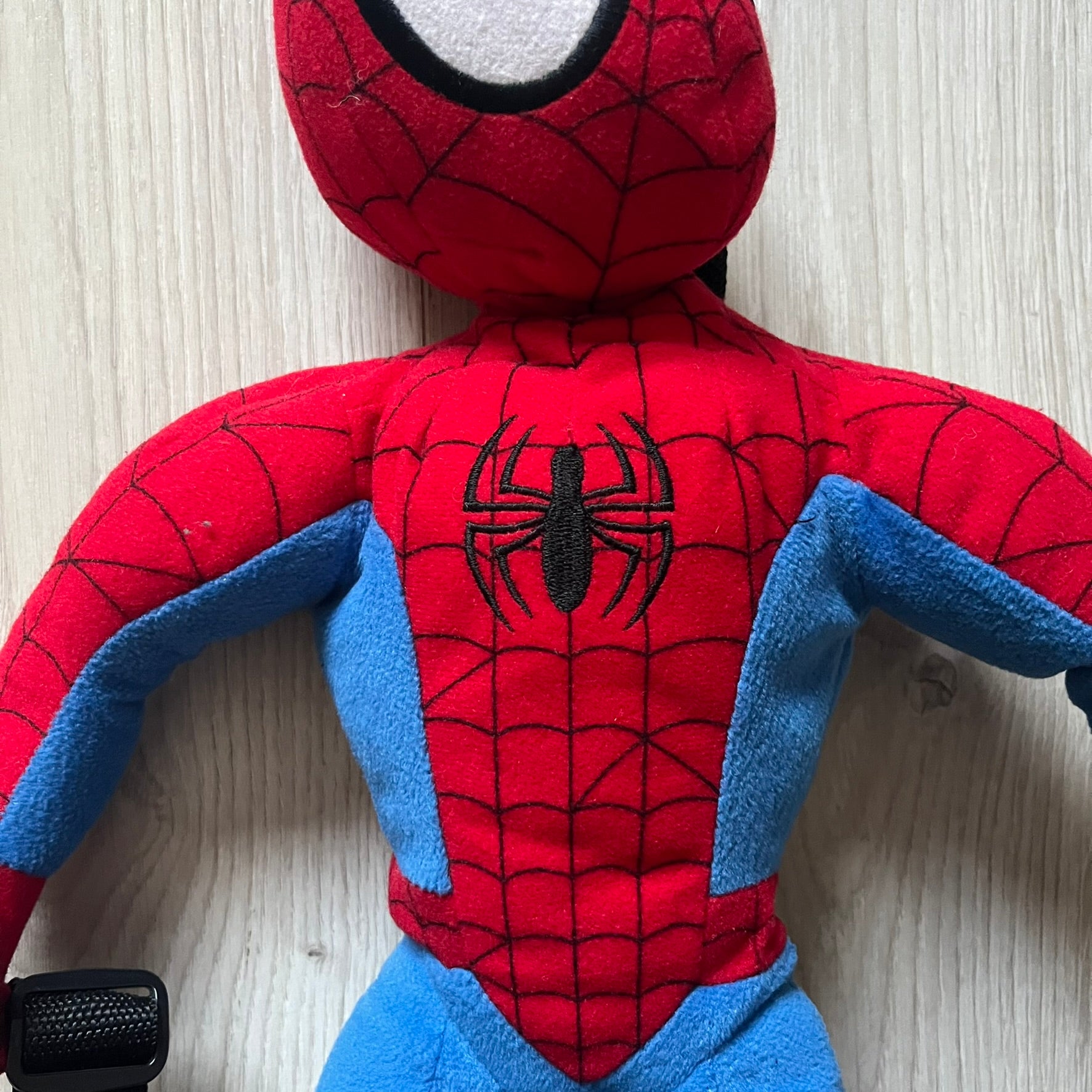 2006 H&M x Marvel Spider-Man Backpack shaped as Spider-Man in his signature red and blue outfit. Features a compact back pocket and unique strap placement connecting his hands to his legs. Rare early 2000s collaboration collectible.