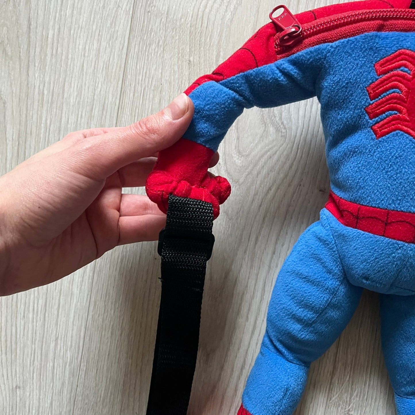 2006 H&M x Marvel Spider-Man Backpack shaped as Spider-Man in his signature red and blue outfit. Features a compact back pocket and unique strap placement connecting his hands to his legs. Rare early 2000s collaboration collectible.