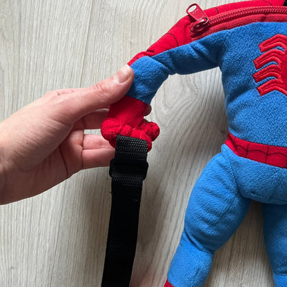 2006 H&M x Marvel Spider-Man Backpack shaped as Spider-Man in his signature red and blue outfit. Features a compact back pocket and unique strap placement connecting his hands to his legs. Rare early 2000s collaboration collectible.