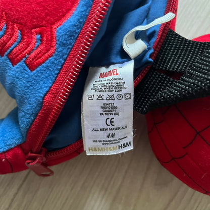2006 H&M x Marvel Spider-Man Backpack shaped as Spider-Man in his signature red and blue outfit. Features a compact back pocket and unique strap placement connecting his hands to his legs. Rare early 2000s collaboration collectible.