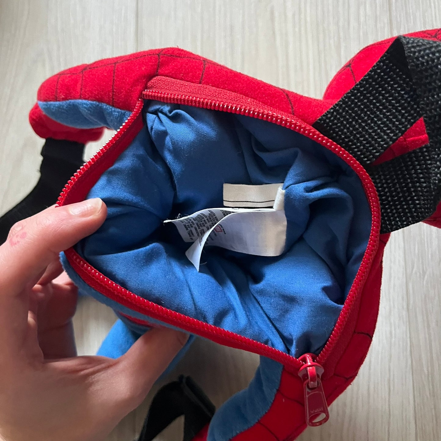 2006 H&M x Marvel Spider-Man Backpack shaped as Spider-Man in his signature red and blue outfit. Features a compact back pocket and unique strap placement connecting his hands to his legs. Rare early 2000s collaboration collectible.