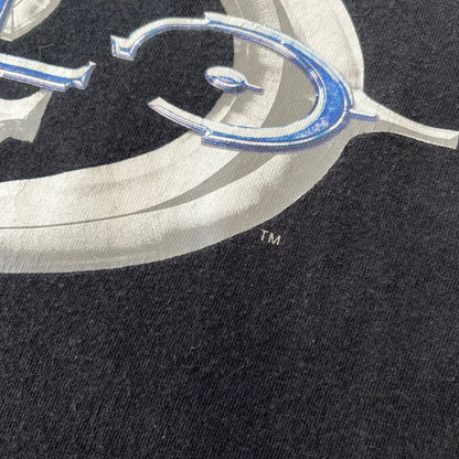 Halo 2 Xbox 2004 Black Tee is a black promotional T-shirt featuring a large white and blue Halo 2 graphic on the front. The upper back has a green original Xbox logo positioned below the collar.