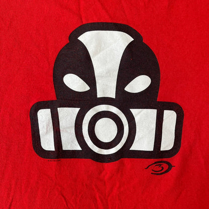 Halo 3 Grunt Emblem 2007 Red Tee features a red T-shirt made on a Gildan blank. The front has a large white and black Grunt emblem graphic, with a small Halo 3 logo below it on the right and Microsoft 2007 licensing text below it on the left. Made from 100% cotton.
