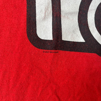 Halo 3 Grunt Emblem 2007 Red Tee features a red T-shirt made on a Gildan blank. The front has a large white and black Grunt emblem graphic, with a small Halo 3 logo below it on the right and Microsoft 2007 licensing text below it on the left. Made from 100% cotton.
