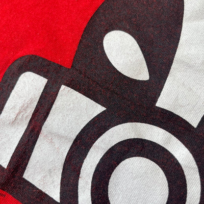 Halo 3 Grunt Emblem 2007 Red Tee features a red T-shirt made on a Gildan blank. The front has a large white and black Grunt emblem graphic, with a small Halo 3 logo below it on the right and Microsoft 2007 licensing text below it on the left. Made from 100% cotton.
