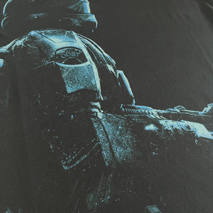 Black Halo 3: ODST Tee for Xbox 360 featuring a large blue Master Chief graphic on the front right and a small logo on the left chest. Made from high-quality cotton with Xbox 360 tags on the collar and a green one on the side. A super rare collectible for Halo fans.