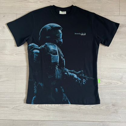 Black Halo 3: ODST Tee for Xbox 360 featuring a large blue Master Chief graphic on the front right and a small logo on the left chest. Made from high-quality cotton with Xbox 360 tags on the collar and a green one on the side. A super rare collectible for Halo fans.