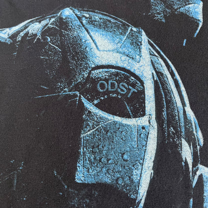 Black Halo 3: ODST Tee for Xbox 360 featuring a large blue Master Chief graphic on the front right and a small logo on the left chest. Made from high-quality cotton with Xbox 360 tags on the collar and a green one on the side. A super rare collectible for Halo fans.