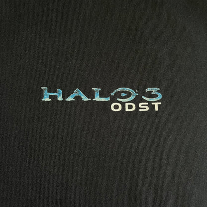 Black Halo 3: ODST Tee for Xbox 360 featuring a large blue Master Chief graphic on the front right and a small logo on the left chest. Made from high-quality cotton with Xbox 360 tags on the collar and a green one on the side. A super rare collectible for Halo fans.